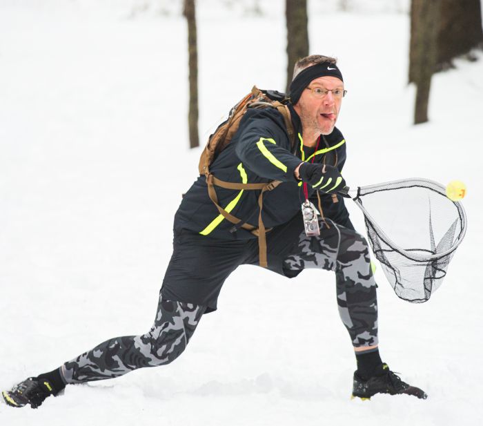 man catching ball in net